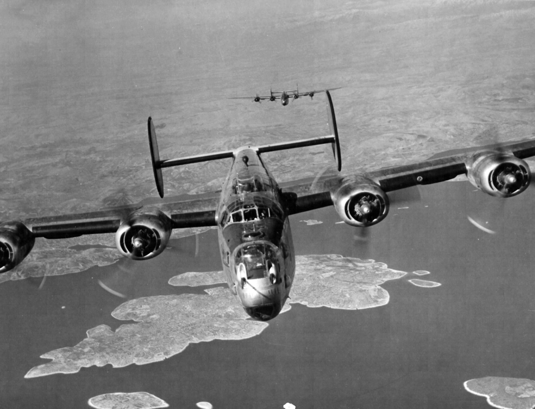 B-24J Liberators of the 15th Air Force return from mission to Mühldorf, Germany to their base in Italy, Mar 19 1945, flying over island of Drvenik Veliki, Yugoslavia (US National Archives)
